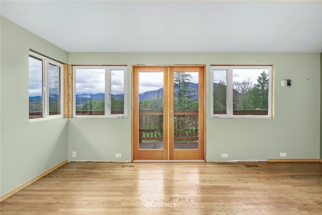 38131 Southeast 91st Street Snoqualmie, WA 98065 - Photo 15 of 40 a view of an empty room with wooden floor and a window