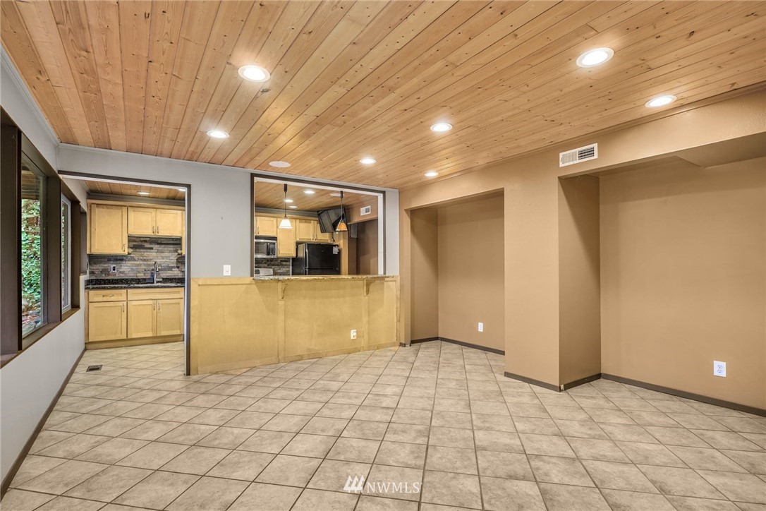 38131 Southeast 91st Street Snoqualmie, WA 98065 - Photo 20 of 40 a view of a hallway with wooden floor and a living room