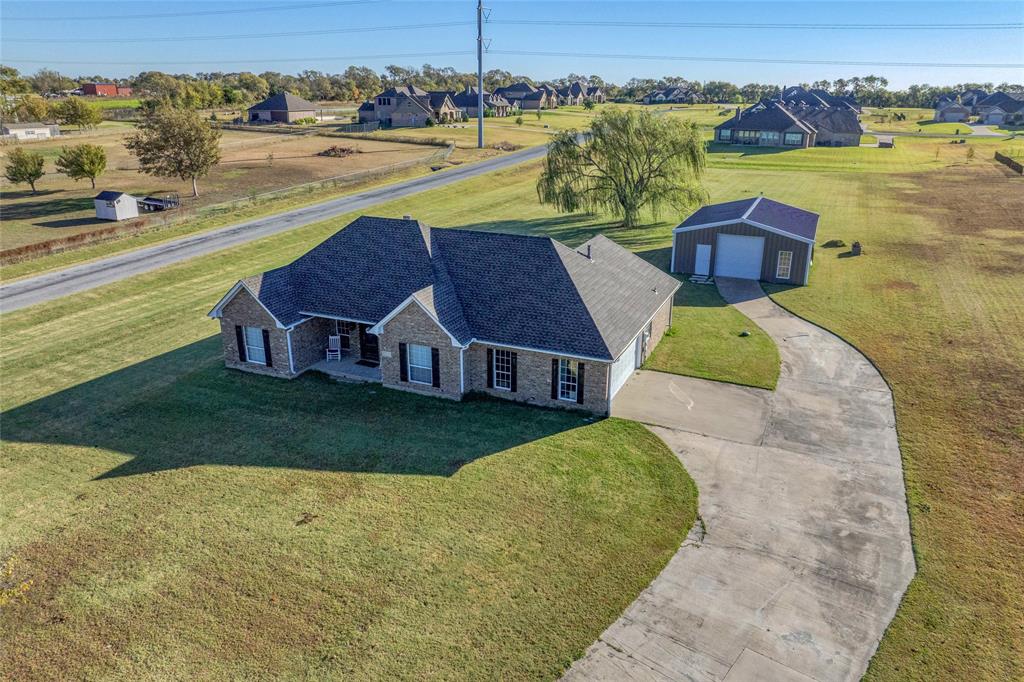 10264 Farmington Road Van Alstyne, TX 75495 - Photo 1 of 39 a view of a lake with a house in the background