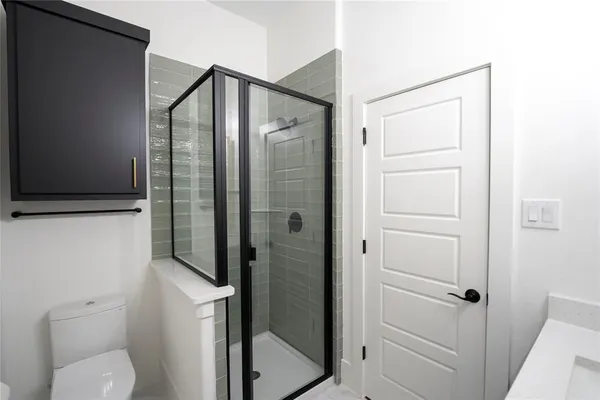 a bathroom with a shower and toilet