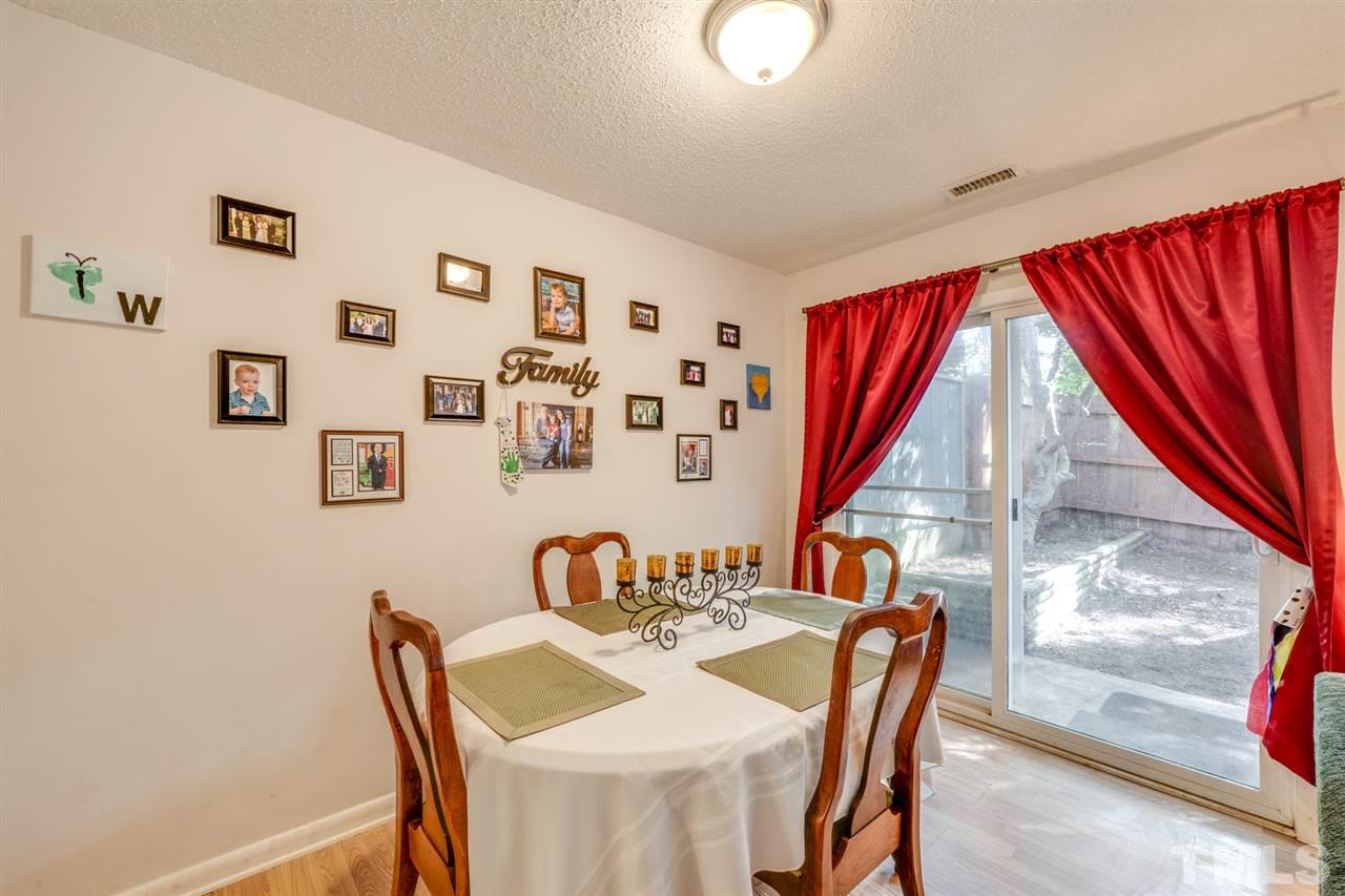 6006 Farm Gate Road Raleigh, NC 27606 - Photo 2 of 21 a view of a dining room with furniture window and wooden floor