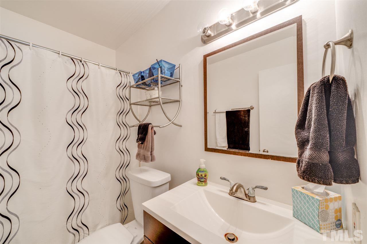 6006 Farm Gate Road Raleigh, NC 27606 - Photo 17 of 21 a bathroom with a sink and a mirror