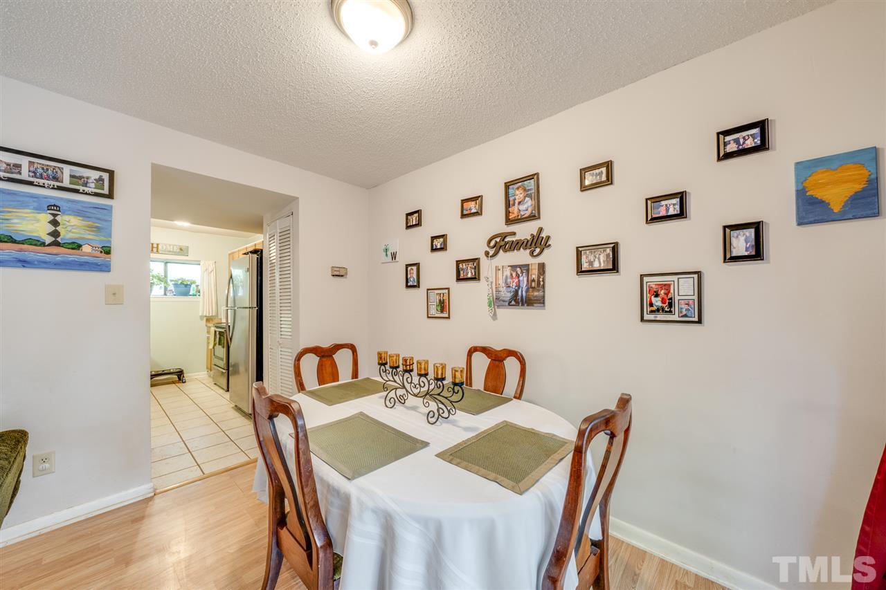 6006 Farm Gate Road Raleigh, NC 27606 - Photo 3 of 21 a view of a dining room with furniture and wooden floor