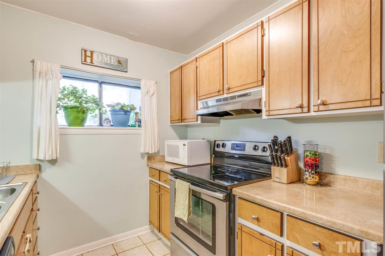 6006 Farm Gate Road Raleigh, NC 27606 - Photo 5 of 21 a kitchen with stainless steel appliances granite countertop a sink a stove and a microwave