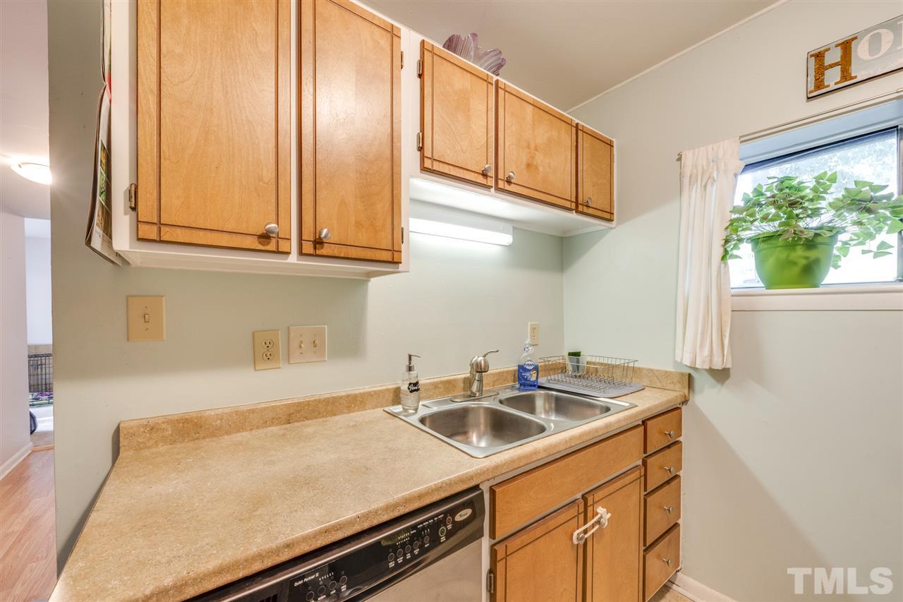 6006 Farm Gate Road Raleigh, NC 27606 - Photo 6 of 21 a kitchen with stainless steel appliances granite countertop a sink and cabinets