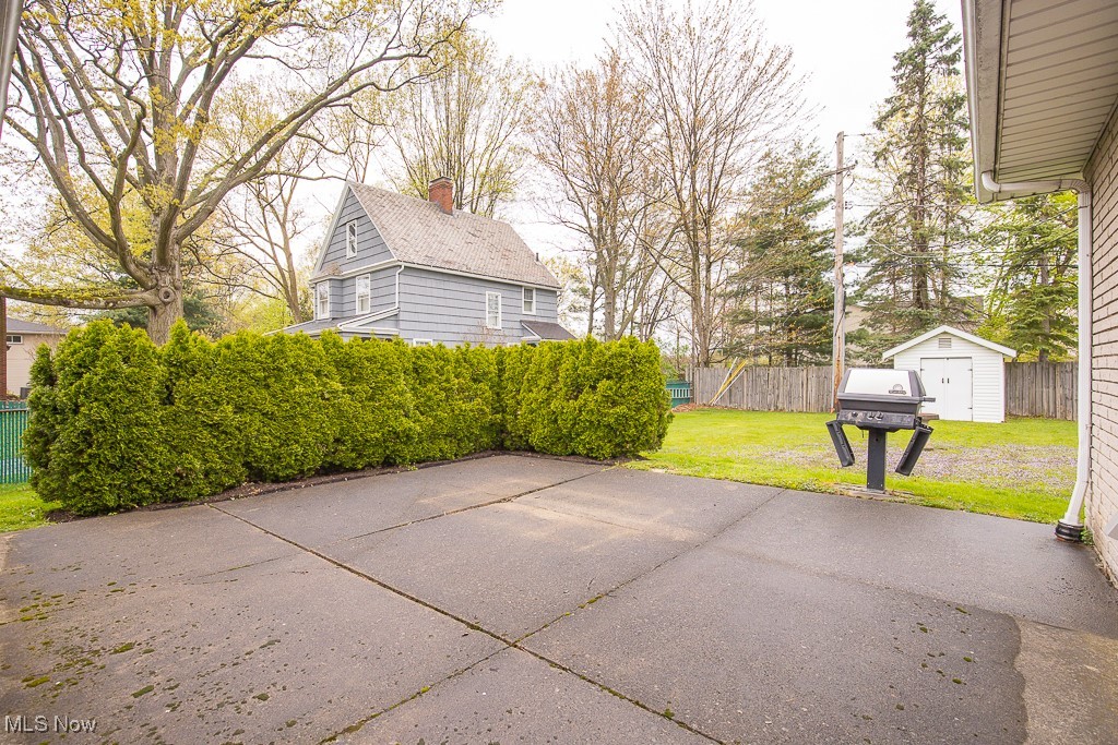 4569 McFarland Road Cleveland, OH 44121 - Photo 25 of 29 View of patio featuring an outbuilding, a shed, and fence