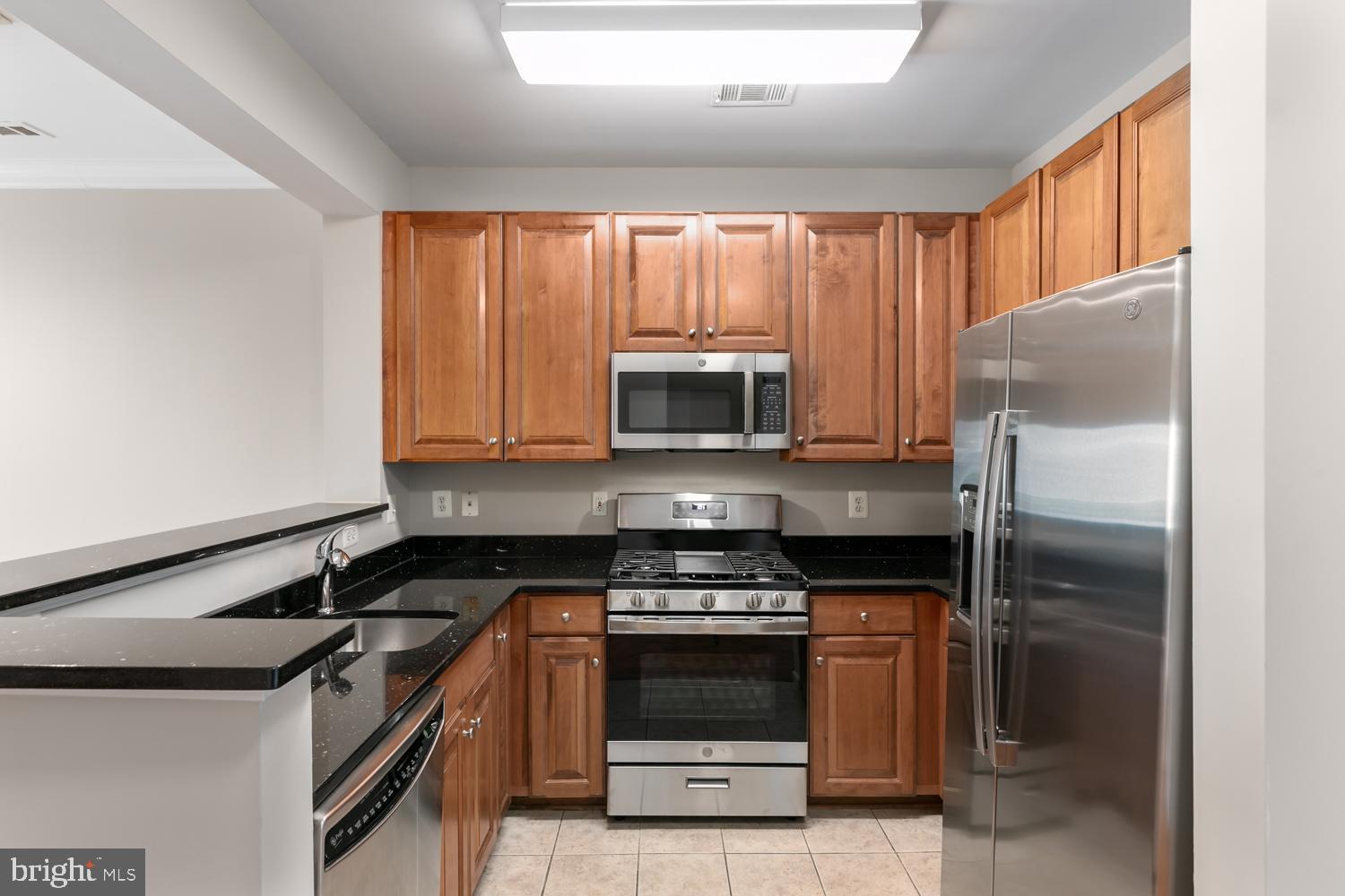 12001 Market Street, Unit 217 Reston, VA 20190 - Photo 2 of 38 Kitchen - new range, refrigerator & microwave