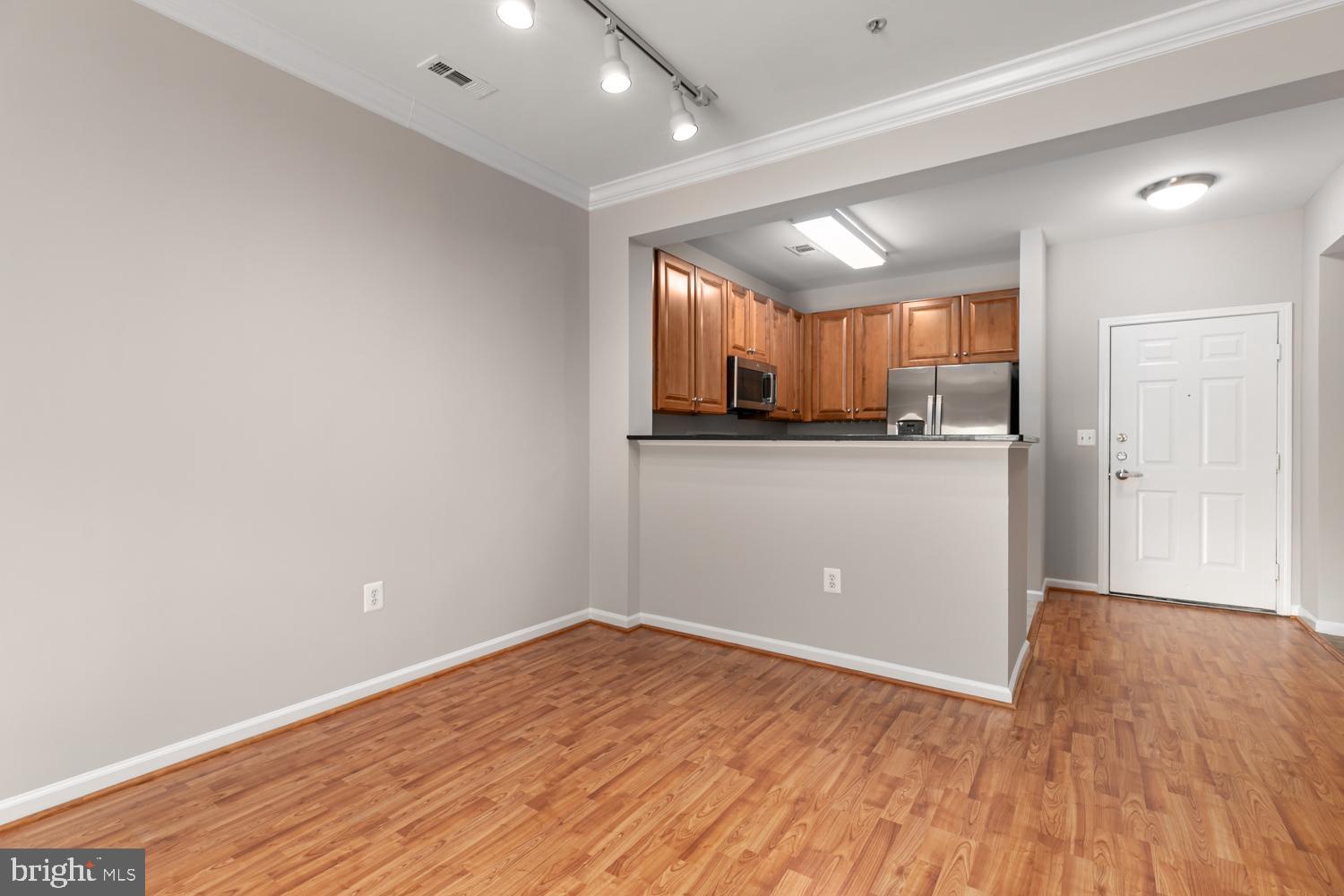 12001 Market Street, Unit 217 Reston, VA 20190 - Photo 7 of 38 Living Rm View 3 with breakfast area