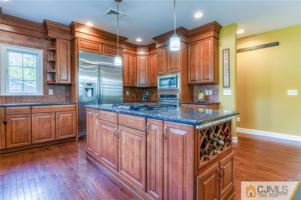 85 Davidson's Mill Road North Brunswick, NJ 08902 - Photo 19 of 39 a kitchen with stainless steel appliances granite countertop a stove a sink and a microwave