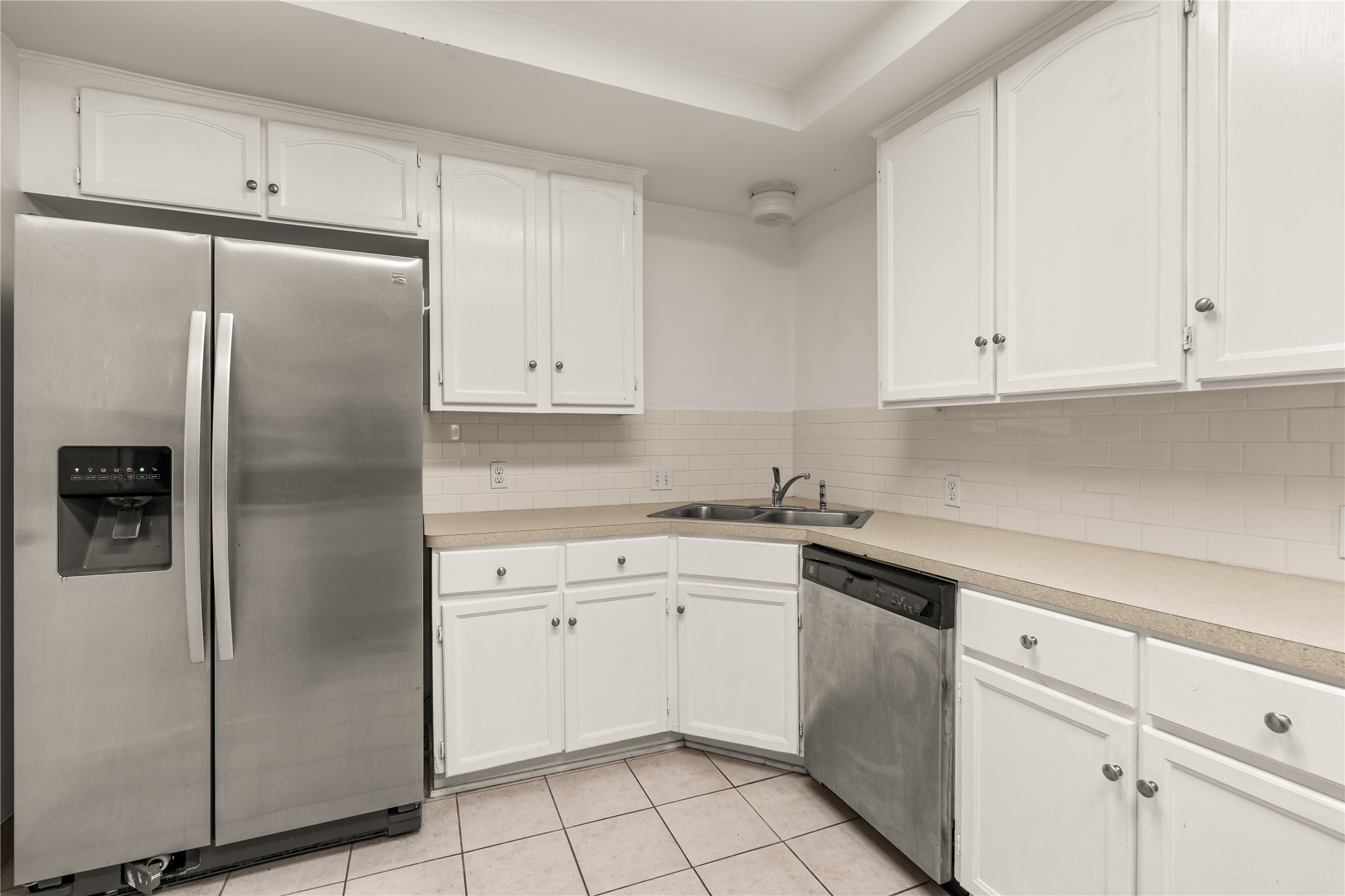 2202 West Main Street Houston, TX 77098 - Photo 12 of 32 a kitchen with white cabinets and refrigerator