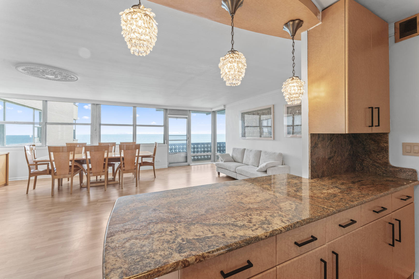 6301 North Sheridan Road, Unit 11R Chicago, IL 60660 - Photo 6 of 17 a view of a kitchen and dining area with granite countertop wooden floor