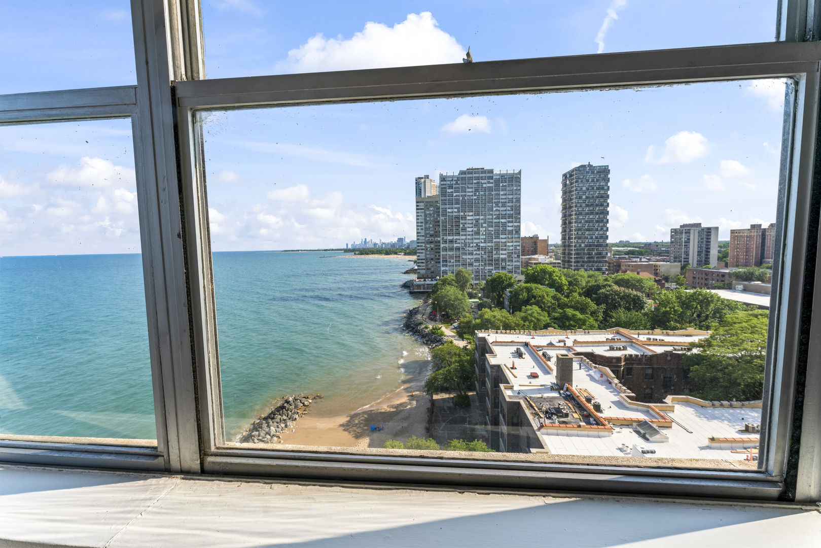 6301 North Sheridan Road, Unit 11R Chicago, IL 60660 - Photo 8 of 17 a view of a window with a tree and a table