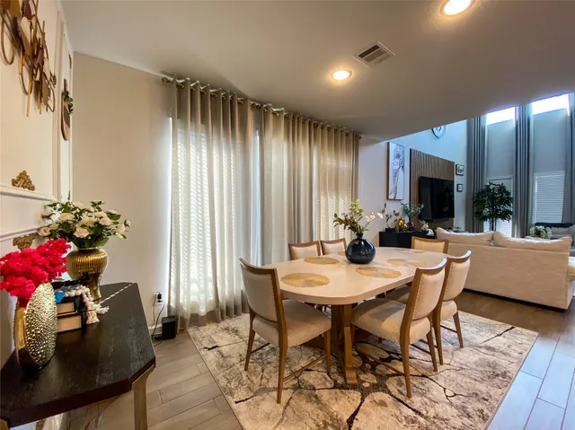 a view of a dining room with furniture and window