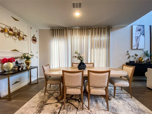 a dining room with furniture and window
