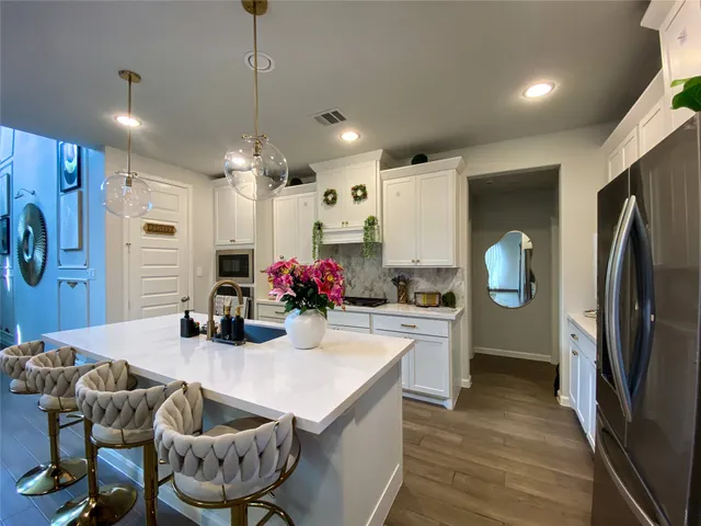 a kitchen with refrigerator and cabinets