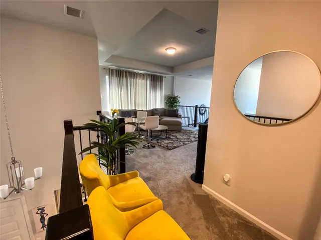 a living room with furniture and a mirror