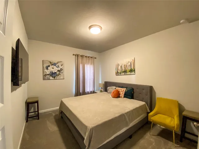 a bedroom with a bed and a table in it