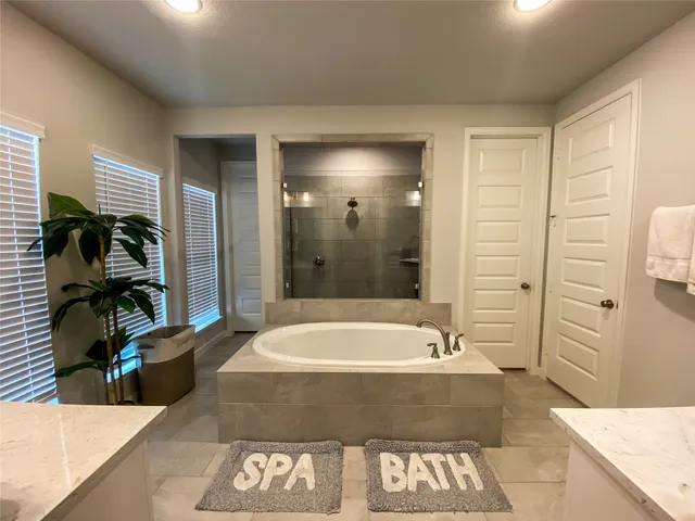 a spacious bathroom with a tub and shower