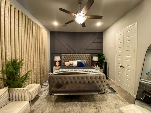 a bedroom with a bed window and a couch