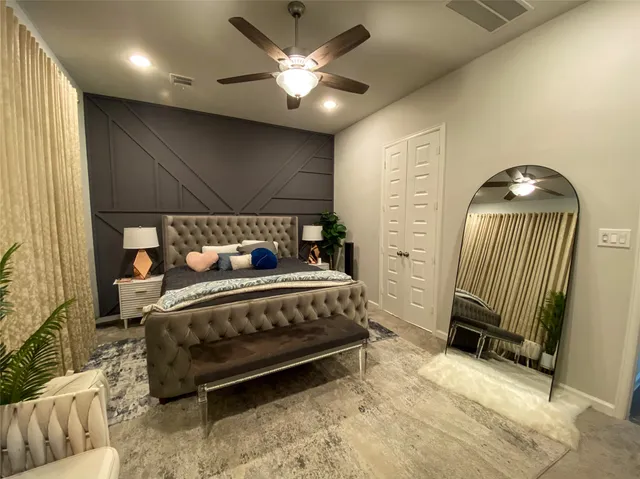 a bedroom with a bed and a chair