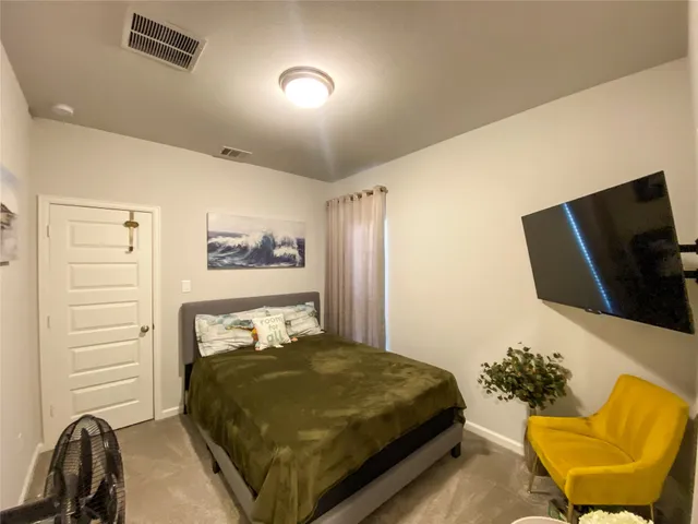 a bedroom with a bed and chair
