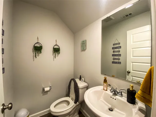 a bathroom with a sink a toilet and mirror