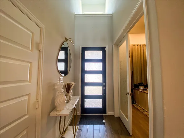 a view of a livingroom with wooden floor and windows