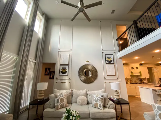 a living room with furniture and a mirror