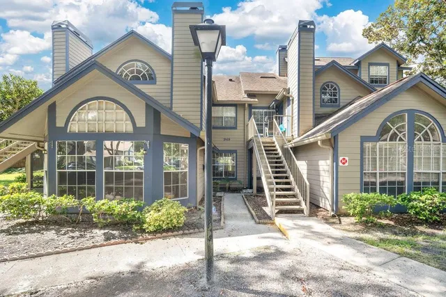a view of a brick house with a large windows and a small yard