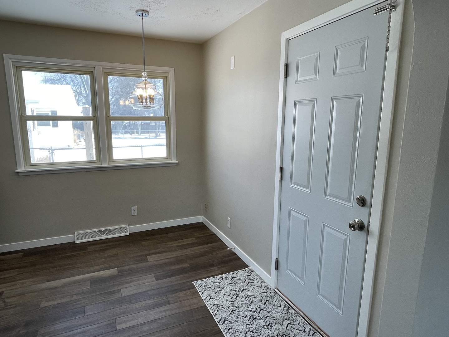 1044 Park Avenue Sycamore, IL 60178 - Photo 11 of 23 a view of an empty room with wooden floor and a window