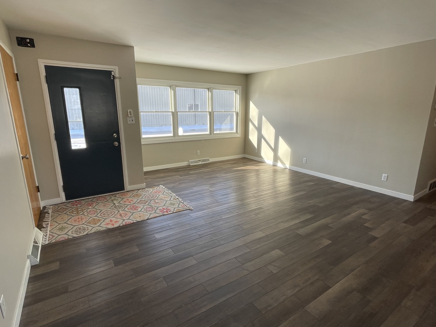 1044 Park Avenue Sycamore, IL 60178 - Photo 4 of 23 a view of an empty room with wooden floor and a window