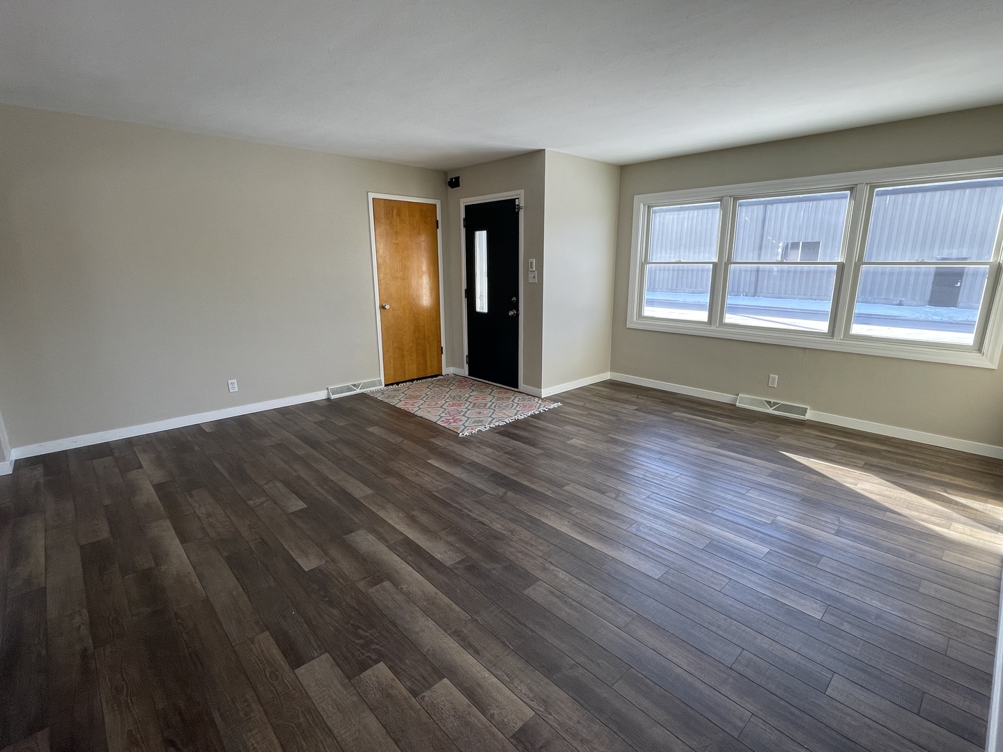 1044 Park Avenue Sycamore, IL 60178 - Photo 5 of 23 a view of an empty room with wooden floor and a window