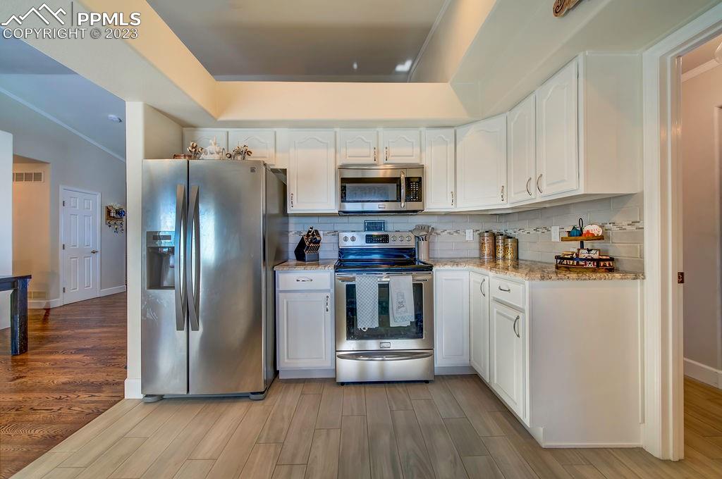 648 South McCulloch Boulevard Pueblo, CO 81007 - Photo 15 of 50 a kitchen with stainless steel appliances a refrigerator sink and microwave