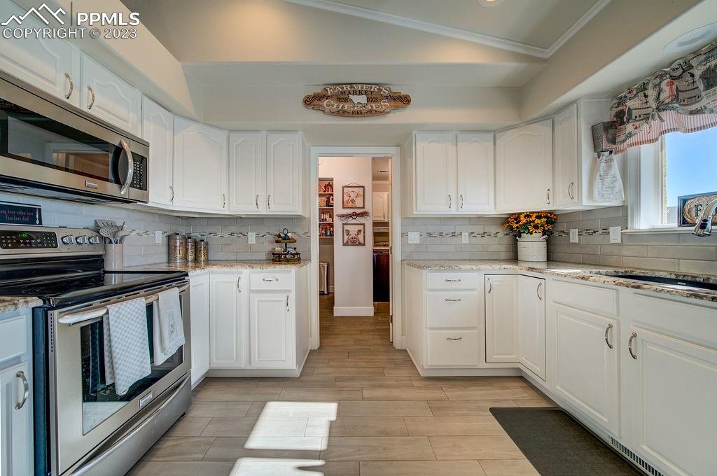 648 South McCulloch Boulevard Pueblo, CO 81007 - Photo 16 of 50 a kitchen with stainless steel appliances granite countertop a stove and cabinets