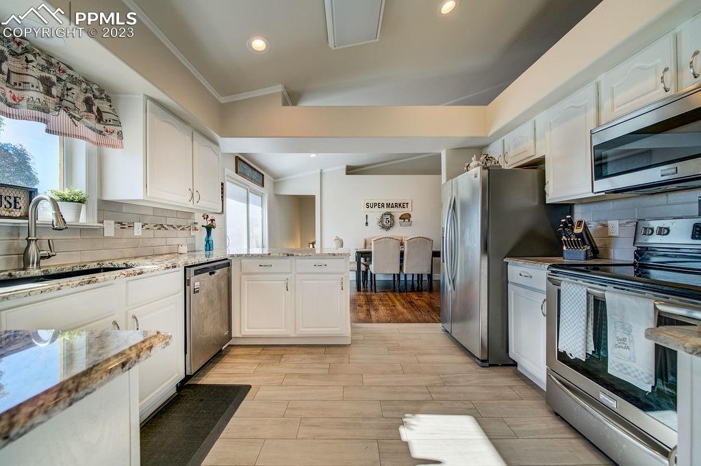 648 South McCulloch Boulevard Pueblo, CO 81007 - Photo 17 of 50 a kitchen with granite countertop appliances cabinets and a sink
