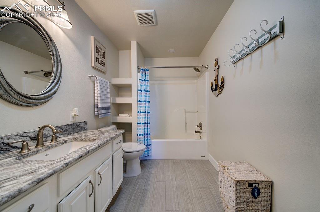 648 South McCulloch Boulevard Pueblo, CO 81007 - Photo 27 of 50 a bathroom with a granite countertop sink toilet and shower