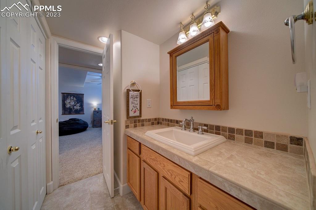 648 South McCulloch Boulevard Pueblo, CO 81007 - Photo 28 of 50 a en suite bathroom with a sink and a mirror