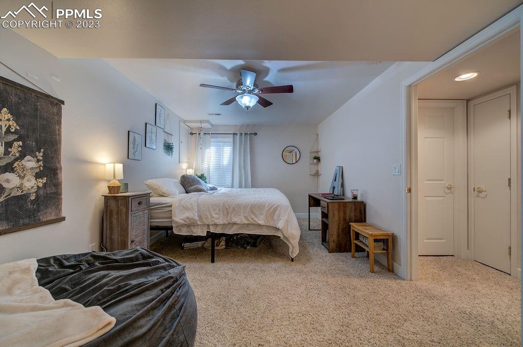 648 South McCulloch Boulevard Pueblo, CO 81007 - Photo 30 of 50 a bedroom with a bed and a chandelier