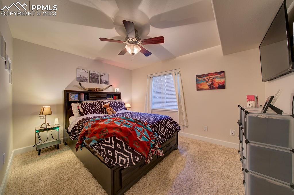 648 South McCulloch Boulevard Pueblo, CO 81007 - Photo 32 of 50 a bedroom with a bed and flat screen tv