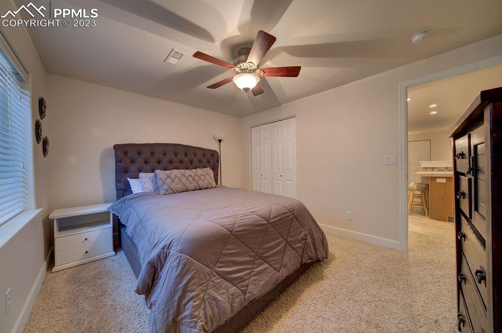 648 South McCulloch Boulevard Pueblo, CO 81007 - Photo 33 of 50 a bedroom with a bed and a chandelier