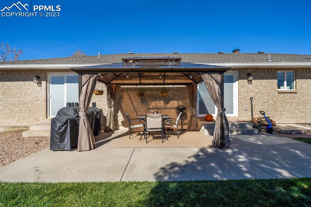 648 South McCulloch Boulevard Pueblo, CO 81007 - Photo 50 of 50 a view of a patio with table and chairs a barbeque