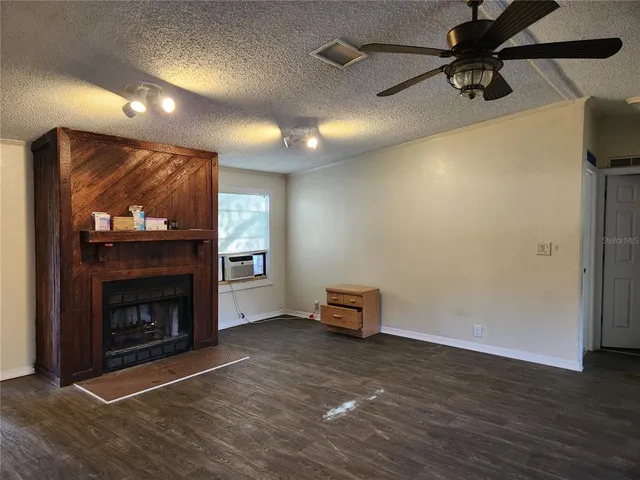 a view of an empty room with a fireplace