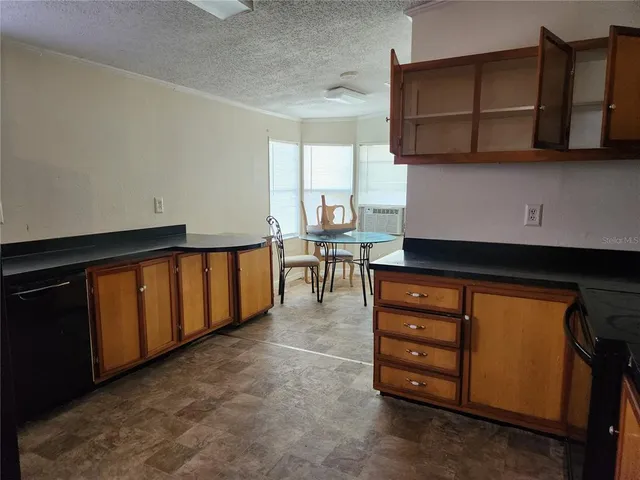 a view of a kitchen with furniture and cabinets