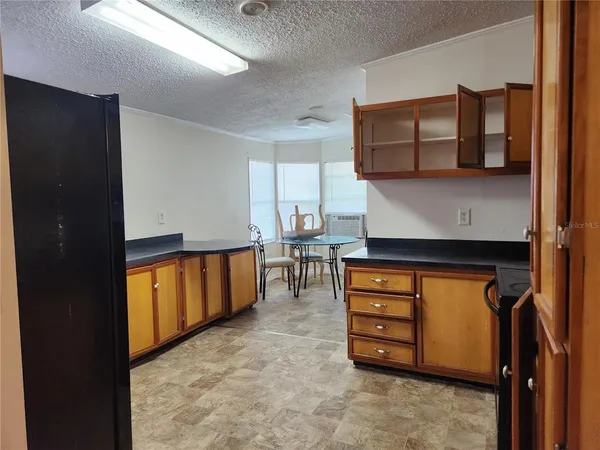 a kitchen with stainless steel appliances granite countertop a refrigerator and a stove