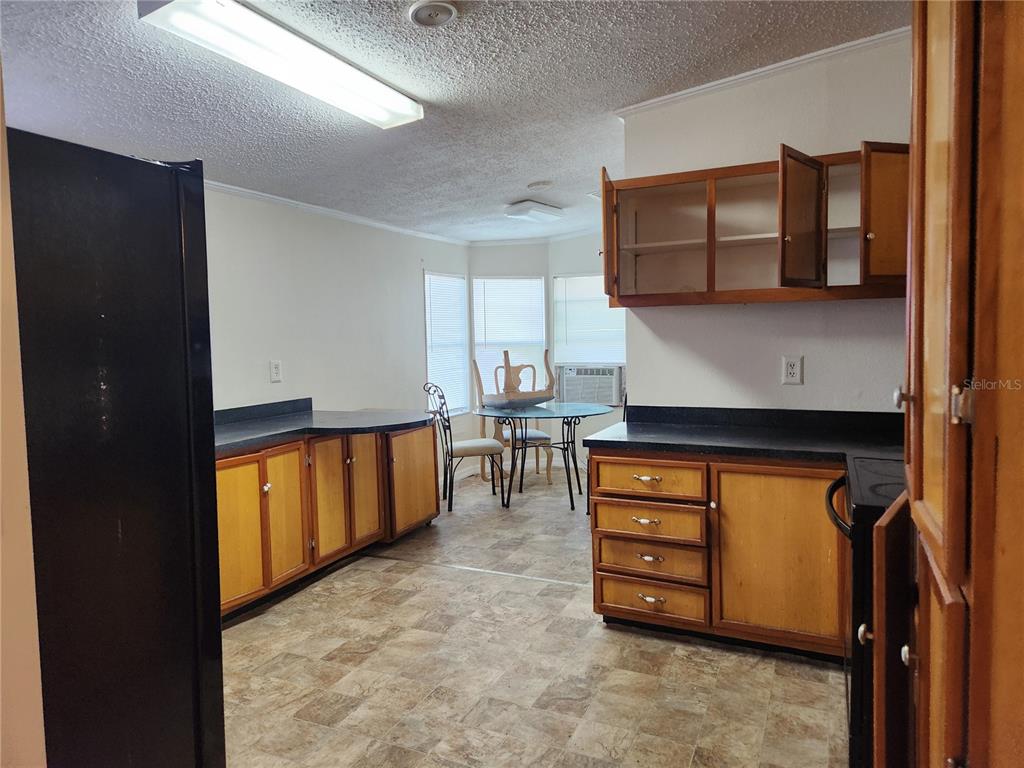 2608 20 Mile Level Road Land O' Lakes, FL 34639 - Photo 16 of 19 a kitchen with stainless steel appliances granite countertop a refrigerator and a stove