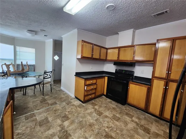 a kitchen with stainless steel appliances granite countertop a refrigerator a stove a sink and dishwasher