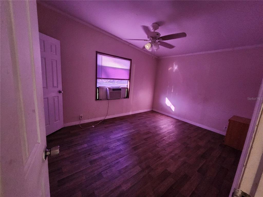 2608 20 Mile Level Road Land O' Lakes, FL 34639 - Photo 7 of 19 a view of empty room with wooden floor and fan