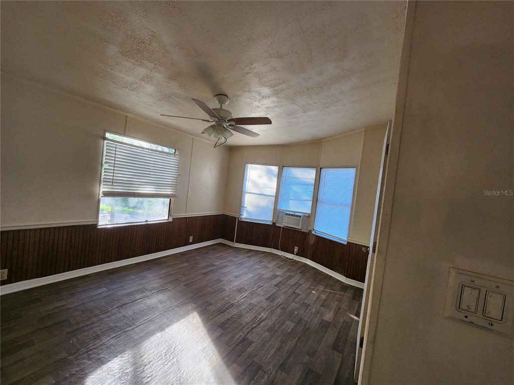 2608 20 Mile Level Road Land O' Lakes, FL 34639 - Photo 8 of 19 wooden floor in an empty room with a window