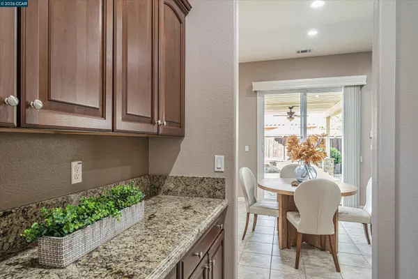 a bathroom with a granite countertop sink a large mirror and a shower
