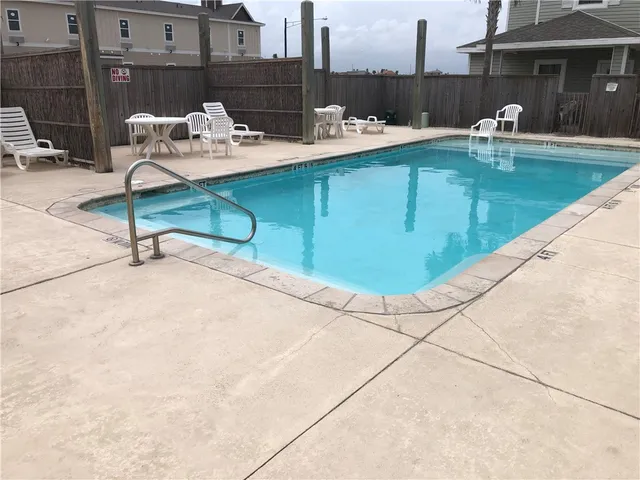 a swimming pool with outdoor seating